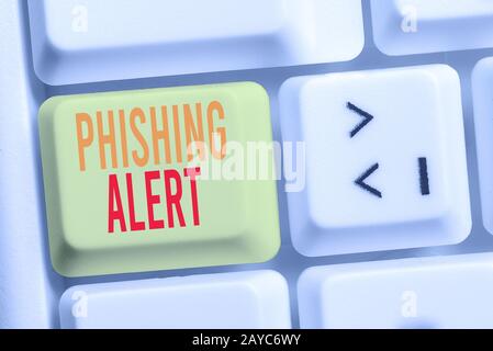 Handwriting text writing Phishing Alert. Concept meaning aware to fraudulent attempt to obtain sensitive information White pc ke Stock Photo