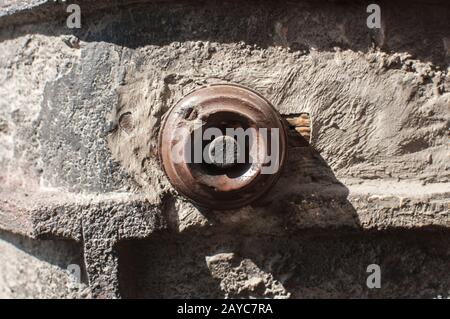 Old vintage retro weathered electric doorbell on grunge house facade Stock Photo