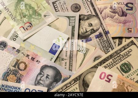 Background of various currency banknotes, dollar, euro, yuan. Stock Photo