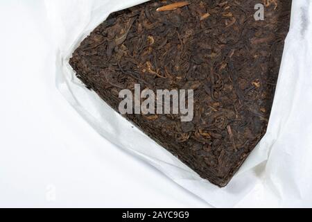 Chinese Yunnan Pu Erh tea block wrapped in white silk paper Stock Photo