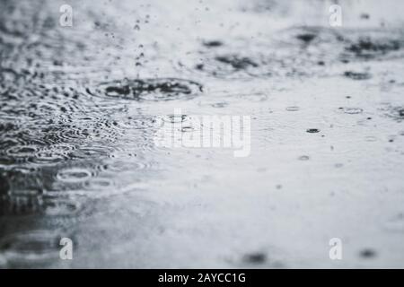 rain drops falling on a street Stock Photo