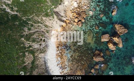 Aerial view of the rocky sea coast and beach of San Blas Bay in Gozo, Malta's smaller island Stock Photo
