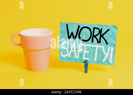 Handwriting text Work Safety. Concept meaning policies and procedures in place to ensure health of employees Cup empty paper blu Stock Photo