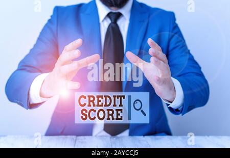 Handwriting text writing Credit Score. Concept meaning creditworthiness of an individual based on credit files Man holds empty p Stock Photo