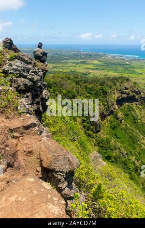 Hiker on the Sleeping Giant, also known as Nounou Mountain, a mountain ridge located west of the towns Wailua and Kapaa in the Nounou Forest Reserve o
