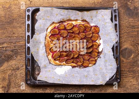 Bavarian plum cake on dark wood Stock Photo