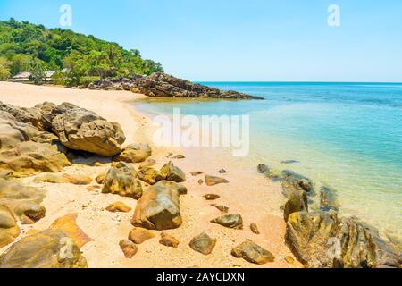 Natural landscape of sea and tropical island with rocks on beach Stock Photo