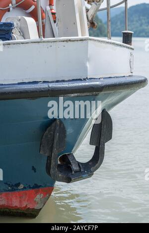 Anchor and lifebuoy at the bow of a ship - closeup Stock Photo