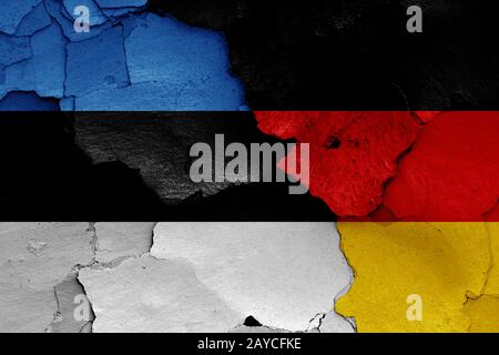 flags of Estonia and Germany painted on cracked wall Stock Photo