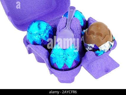 Carton of cream filled chocolate eggs isolated on a white background Stock Photo