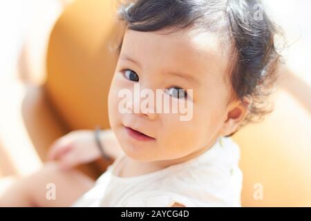 Portrait of cute and lovely curly hair asian chinese baby girl . Stock Photo
