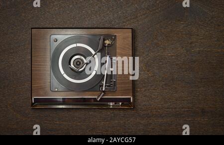 Old vintage retro wooden vinyl record player on wooden background Stock Photo