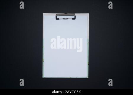 Blank white note board . Flat lay and top view with copy space on black background . Stock Photo
