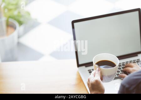 Coffee in businessman hand with Laptop  . Stock Photo