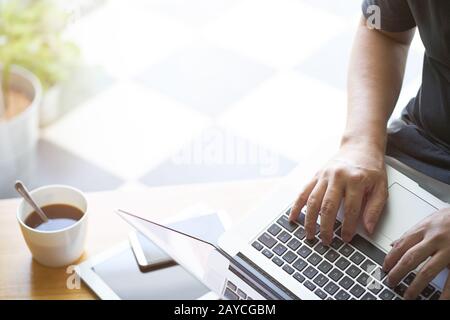 Laptop in businessman hand with digital tablet Stock Photo