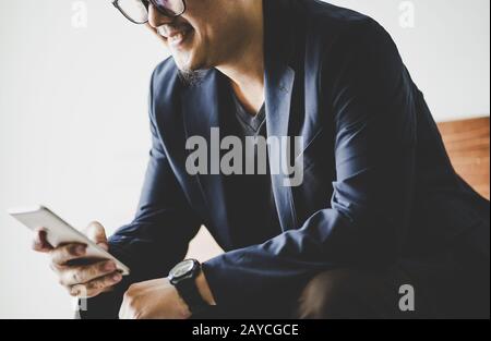 Closeup of businessman using smartphone . Stock Photo