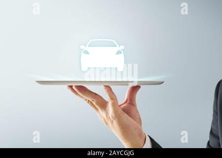 Waiter hand holding an empty digital tablet with virtual screen dispaly a car Stock Photo