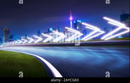 Motion blurred racetrack with city skyline background Stock Photo