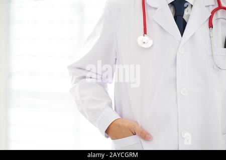 Unknown doctor posing  hand in pocket in the office Stock Photo