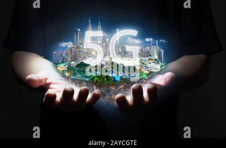 Unknown hand holding fantasy island floating in the air with 5G network wireless systems Stock Photo