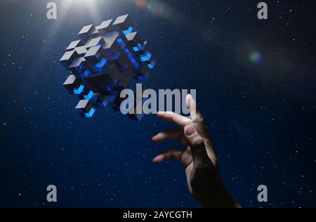 Unknown hand touching floating blue shiny cube on dark background . Stock Photo