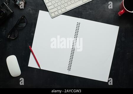Wooden black office desk table with notebook Stock Photo