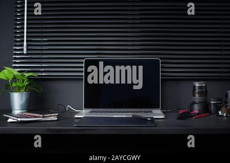 Work space on black table of a photographer or designer with laptop Stock Photo