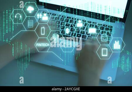 Fintech word on digital virtual screen with male hands typing laptop background. Hi-tech business concept . Stock Photo