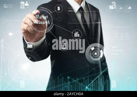 Businessman draw Market Research word on digital virtual screen . Hi-tech business concept . Stock Photo