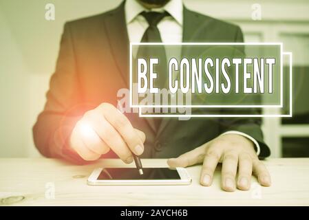 Handwriting text writing Be Consistent. Concept meaning Uniform Persistent Firm Unalterable Even Unchanging Rapport. Stock Photo