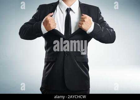 young businessman in superhero action with black suit Stock Photo
