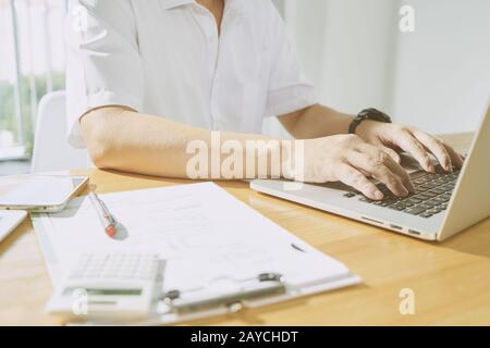 Close up view of businessman using laptop to work . Stock Photo
