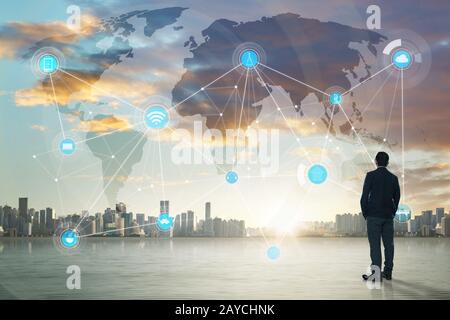 International business concept with businessman on city skyline background with network on map and sunlight Stock Photo