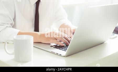 Businessman hands working on laptop Stock Photo