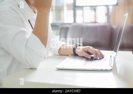 Man's hands typing on laptop keyboard .close up and selected focus . Stock Photo