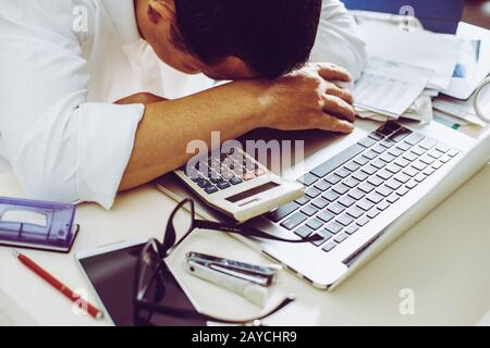 Accountant businessman working in office having a stress. Stock Photo