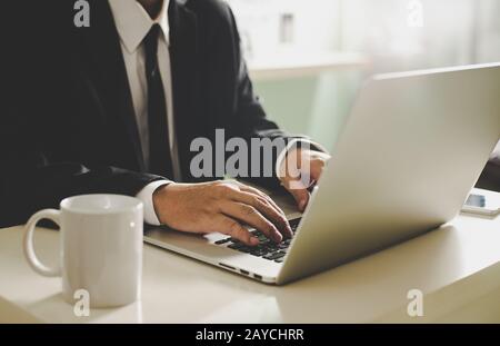 Businessman hands working on laptop Stock Photo