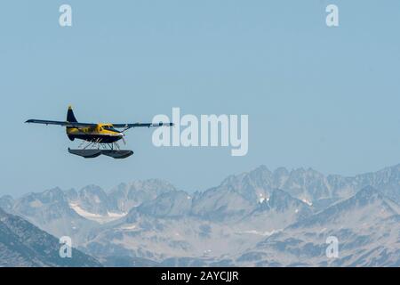 A seaplane is flying over Lake Crescent in Lake Clark National Park and Preserve, Alaska, USA. Stock Photo