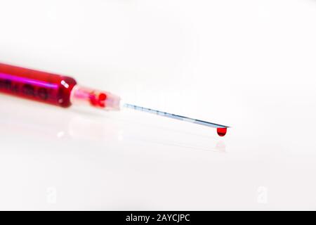 Syringe with blood on white background Stock Photo