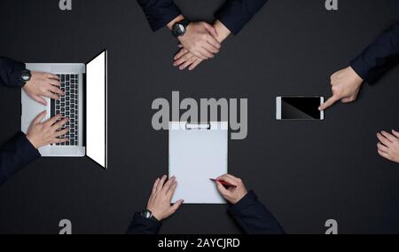 Group of business people working together . Flat lay and top view with copy space on black background .Business brainstorming me Stock Photo