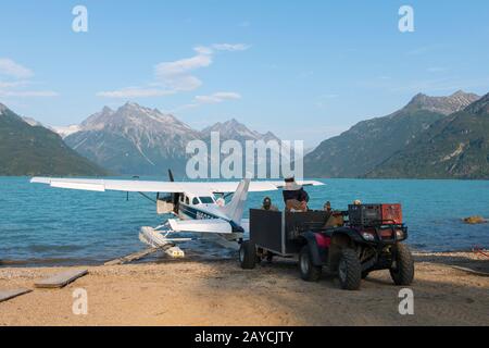 A seaplane is being unloaded at the Redoubt Mountain Lodge on Lake Crescent in Lake Clark National Park and Preserve, Alaska, USA. Stock Photo