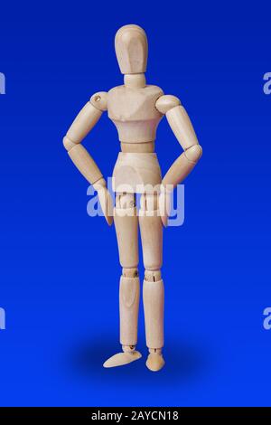 Dancing wooden toy figure on blue Stock Photo