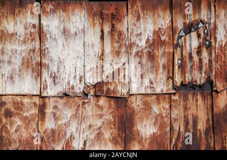 Old weathered corroded rusty tin wall surface panels closeup as grunge background Stock Photo