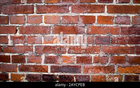 Weathered stained old brick wall background Stock Photo