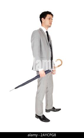 Young handsome man standing with a umbrella Stock Photo