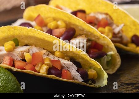 three Mexican tacos on slate Stock Photo