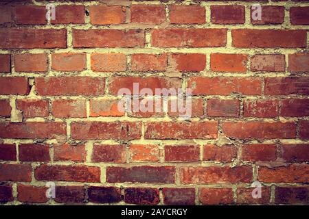 Weathered stained old brick wall background Stock Photo