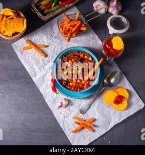 chili con carne with sweet potato and spicy nachos Stock Photo