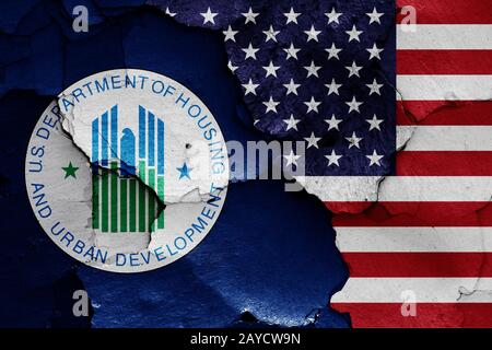 flags of Department of Housing and Urban Development and USA painted on cracked wall Stock Photo