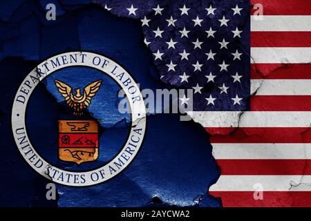 flags of Department of Labor and USA painted on cracked wall Stock Photo